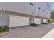 Attached garages for townhomes with paved driveway, lush landscaping, and garage door openers at 1767 Piedmont Pl, Lake Mary, FL 32746