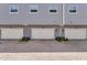 Attached garages for townhomes with paved driveway, lush landscaping, and garage door openers at 1767 Piedmont Pl, Lake Mary, FL 32746