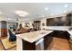 Open concept kitchen with dark cabinets, granite countertops, stainless appliances and island bar seating at 1767 Piedmont Pl, Lake Mary, FL 32746