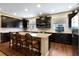 Kitchen with dark cabinets, stainless appliances, wood floors and granite countertops at 1767 Piedmont Pl, Lake Mary, FL 32746