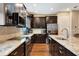 Well lit kitchen features dark cabinets, stainless appliances, granite countertops and wood floors at 1767 Piedmont Pl, Lake Mary, FL 32746