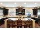 Kitchen with dark cabinets, subway tile backsplash, granite countertops, and bar seating at 1767 Piedmont Pl, Lake Mary, FL 32746