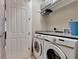 The laundry room features front loading washer and dryer with folding counter at 1767 Piedmont Pl, Lake Mary, FL 32746
