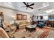 Cozy living room featuring elegant furniture, a ceiling fan, and a decorative rug at 1767 Piedmont Pl, Lake Mary, FL 32746