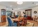 Open concept dining and living space featuring wood floors, dark cabinets and china cabinets with glass doors at 1767 Piedmont Pl, Lake Mary, FL 32746