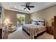 Inviting main bedroom with tray ceiling, a ceiling fan, and a private balcony at 1767 Piedmont Pl, Lake Mary, FL 32746