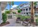 Inviting patio space with comfortable seating, surrounded by lush landscaping and a white picket fence at 1767 Piedmont Pl, Lake Mary, FL 32746