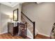 Hallway with a staircase and wine rack, adjacent to a decorative mirror and cabinet at 1767 Piedmont Pl, Lake Mary, FL 32746