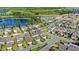 Aerial view of a neighborhood featuring well-maintained lawns, sidewalks, and manicured landscaping by a lake at 17985 Adrift Rd, Winter Garden, FL 34787