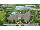 Community aerial view with a pool, surrounded by palm trees and a picturesque lake at 17985 Adrift Rd, Winter Garden, FL 34787