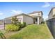 Expansive backyard with lush green lawn, decorative tree, and covered patio at 17985 Adrift Rd, Winter Garden, FL 34787