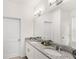Bathroom featuring a granite-topped double vanity, a large mirror, and two entry doors at 17985 Adrift Rd, Winter Garden, FL 34787