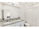 Bathroom featuring a double sink vanity with granite countertops, and a shower and toilet at 17985 Adrift Rd, Winter Garden, FL 34787