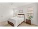 Bright bedroom featuring a wooden bed frame, two windows, and side tables with lamps at 17985 Adrift Rd, Winter Garden, FL 34787