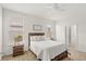 Cozy bedroom with a wood-frame bed, neutral-toned walls, and natural light from two windows at 17985 Adrift Rd, Winter Garden, FL 34787
