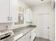 A well-appointed butler's pantry featuring granite counters, cabinets, and backyard view at 17985 Adrift Rd, Winter Garden, FL 34787
