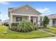 Charming home featuring manicured lawn, lush landscaping, inviting front porch and classic architectural details at 17985 Adrift Rd, Winter Garden, FL 34787