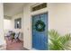 Home's entrance with a blue door, a wreath, and an inviting covered porch with chairs at 17985 Adrift Rd, Winter Garden, FL 34787