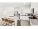 Modern kitchen with white cabinets, stainless steel appliances, and a granite countertop island at 17985 Adrift Rd, Winter Garden, FL 34787