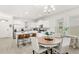 Modern kitchen seamlessly flowing into the dining area, featuring an island with seating at 17985 Adrift Rd, Winter Garden, FL 34787