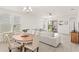 Bright living room with neutral tones, stylish furniture, and sliding glass doors to the outdoor patio at 17985 Adrift Rd, Winter Garden, FL 34787