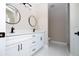 Bathroom featuring double sink vanity, modern lighting, and marble-look tiled floors at 2041 Warrens Ave, Maitland, FL 32751