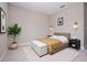 A bright bedroom with tan walls, neutral carpet, side tables, and a padded bench at the foot of the bed at 2041 Warrens Ave, Maitland, FL 32751