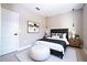 Well-lit bedroom with carpeted floor, tufted headboard, and stylish bedside tables at 2041 Warrens Ave, Maitland, FL 32751