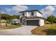 Two-story home with a gray roof, a gray two-car garage door, and a well-maintained lawn at 2041 Warrens Ave, Maitland, FL 32751