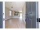 Open concept living room and kitchen with light, wood-look floors and an island with bar seating at 2041 Warrens Ave, Maitland, FL 32751