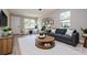Cozy living room featuring bright natural light, a plush sofa, and a contemporary round coffee table at 2041 Warrens Ave, Maitland, FL 32751