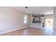 Open floor plan with wood-look flooring, bright, neutral walls and a view into the modern kitchen at 2041 Warrens Ave, Maitland, FL 32751
