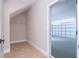 Unfinished storage room with a door leading to a garage, and wood-look flooring at 2041 Warrens Ave, Maitland, FL 32751