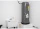 Utility room featuring a Rheem water heater and utility sink at 2041 Warrens Ave, Maitland, FL 32751
