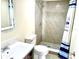Modern bathroom featuring a tiled shower with glass door and a contemporary vanity with sink at 213 S Lake Pleasant Rd, Apopka, FL 32703