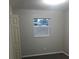 A simple bedroom with neutral colors and a bright window looking out to the exterior at 213 S Lake Pleasant Rd, Apopka, FL 32703