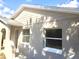 Charming front exterior showcasing arched entryway, textured wall, and windows under a bright sky at 213 S Lake Pleasant Rd, Apopka, FL 32703