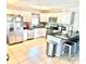 Bright and spacious kitchen featuring stainless steel appliances, a breakfast bar, and white cabinets at 213 S Lake Pleasant Rd, Apopka, FL 32703