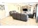 Bright living room featuring tile floors, gray furniture, and a TV entertainment center for cozy gatherings at 213 S Lake Pleasant Rd, Apopka, FL 32703