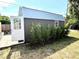 The outbuilding features a gray exterior and natural lighting to grow plants inside at 213 S Lake Pleasant Rd, Apopka, FL 32703
