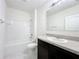 Bright bathroom featuring a tub/shower combo and a vanity with a sink and countertop at 2312 Rose Blvd, Winter Haven, FL 33881