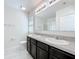 Bathroom featuring a double sink vanity, neutral walls, and a tiled floor at 2312 Rose Blvd, Winter Haven, FL 33881