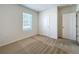 Bedroom with carpet flooring, a bright window, and a white door at 2312 Rose Blvd, Winter Haven, FL 33881