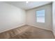 Cozy bedroom with neutral carpet, a window with blinds, and ample natural light at 2312 Rose Blvd, Winter Haven, FL 33881
