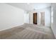 Spacious bedroom with neutral carpet and attached bathroom and closet doors at 2312 Rose Blvd, Winter Haven, FL 33881