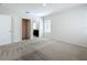 A neutral bedroom with carpet and an open door to an attached bathroom at 2312 Rose Blvd, Winter Haven, FL 33881