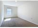 Bedroom with neutral carpet, a window with blinds, and ample natural light at 2312 Rose Blvd, Winter Haven, FL 33881