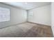 Bright bedroom featuring neutral walls, plush carpet, and natural light from two windows at 2312 Rose Blvd, Winter Haven, FL 33881