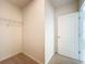 Walk-in closet with carpeted floor, wire shelving, and a white door at 2312 Rose Blvd, Winter Haven, FL 33881