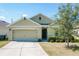 Charming single-story home featuring a two-car garage, well-maintained lawn and manicured shrubbery at 2312 Rose Blvd, Winter Haven, FL 33881